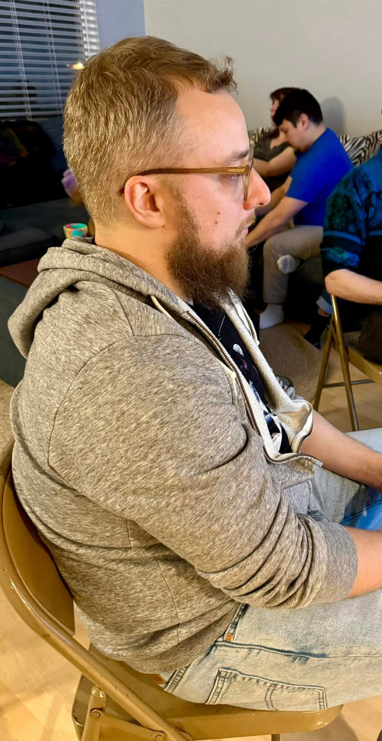 A side-profile picture of me. I have a beard, glasses and I'm holding a controller which is outside the crop